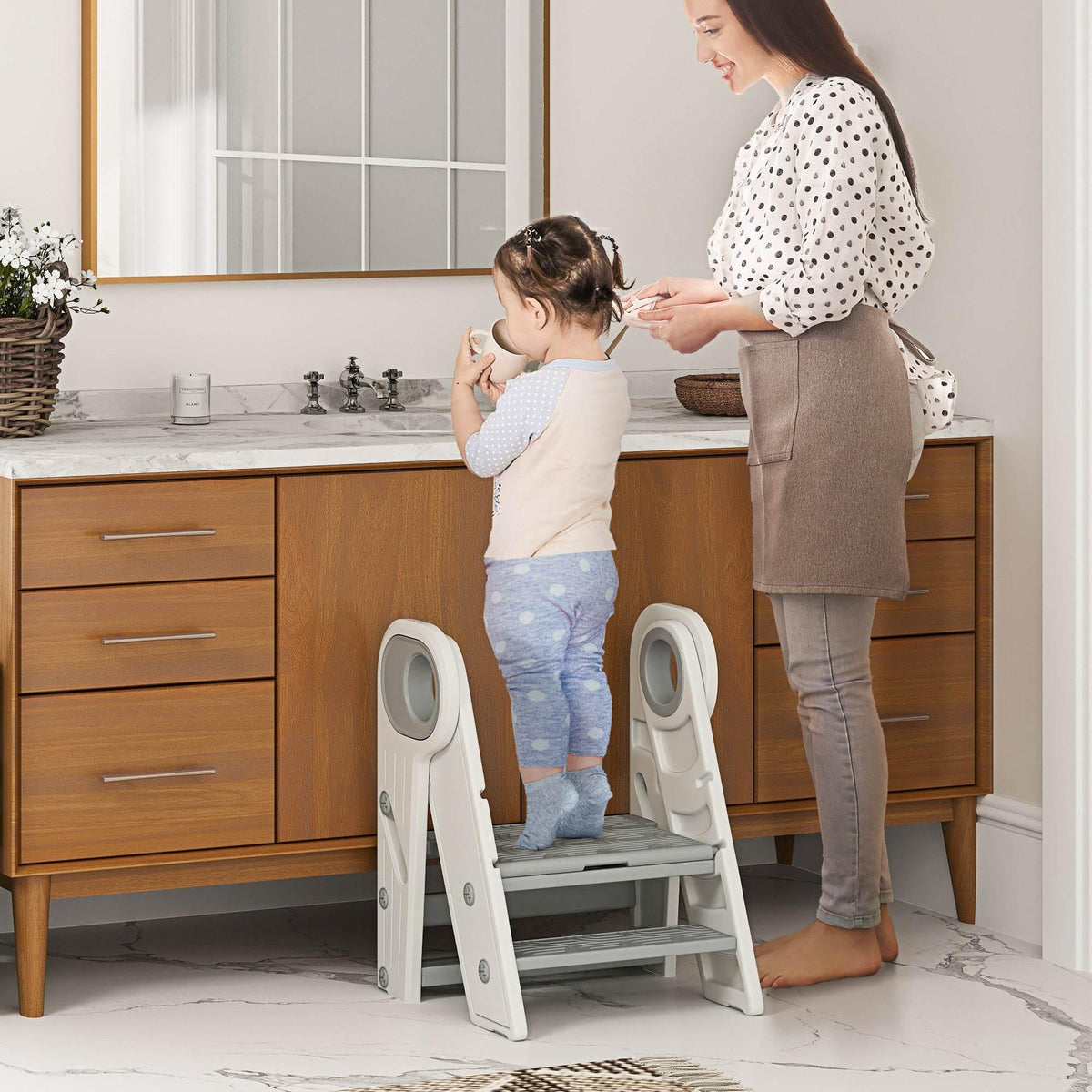 Adjustable toddler step stool with light gray steps and anti-slip surface, folded support.