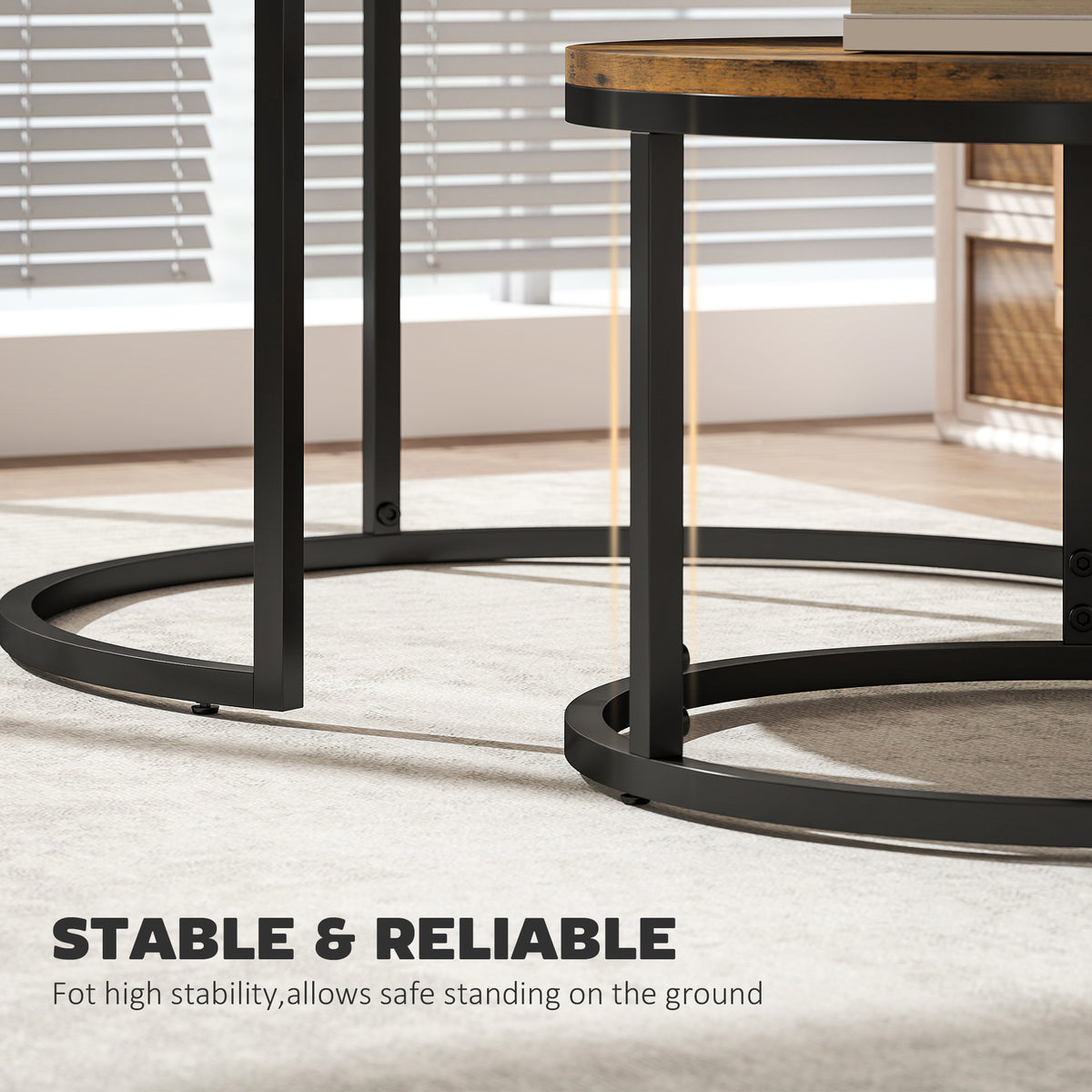 Close-up of black metal legs and circular base rings on rustic brown round nesting tables