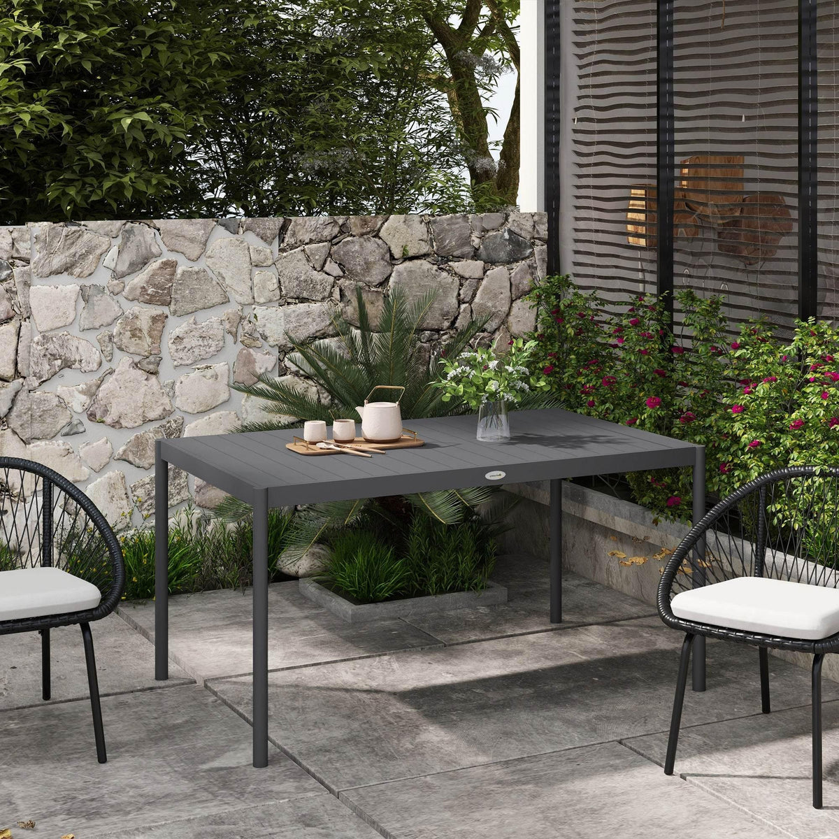 Dark gray square outdoor dining table with four legs and small round center badge