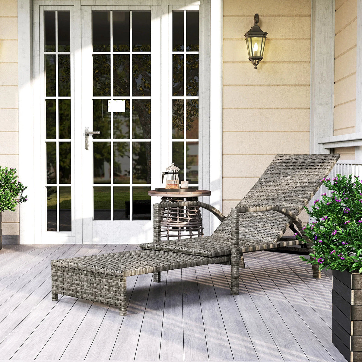 Grey rattan reclining lounger with extended footrest and adjustable backrest
