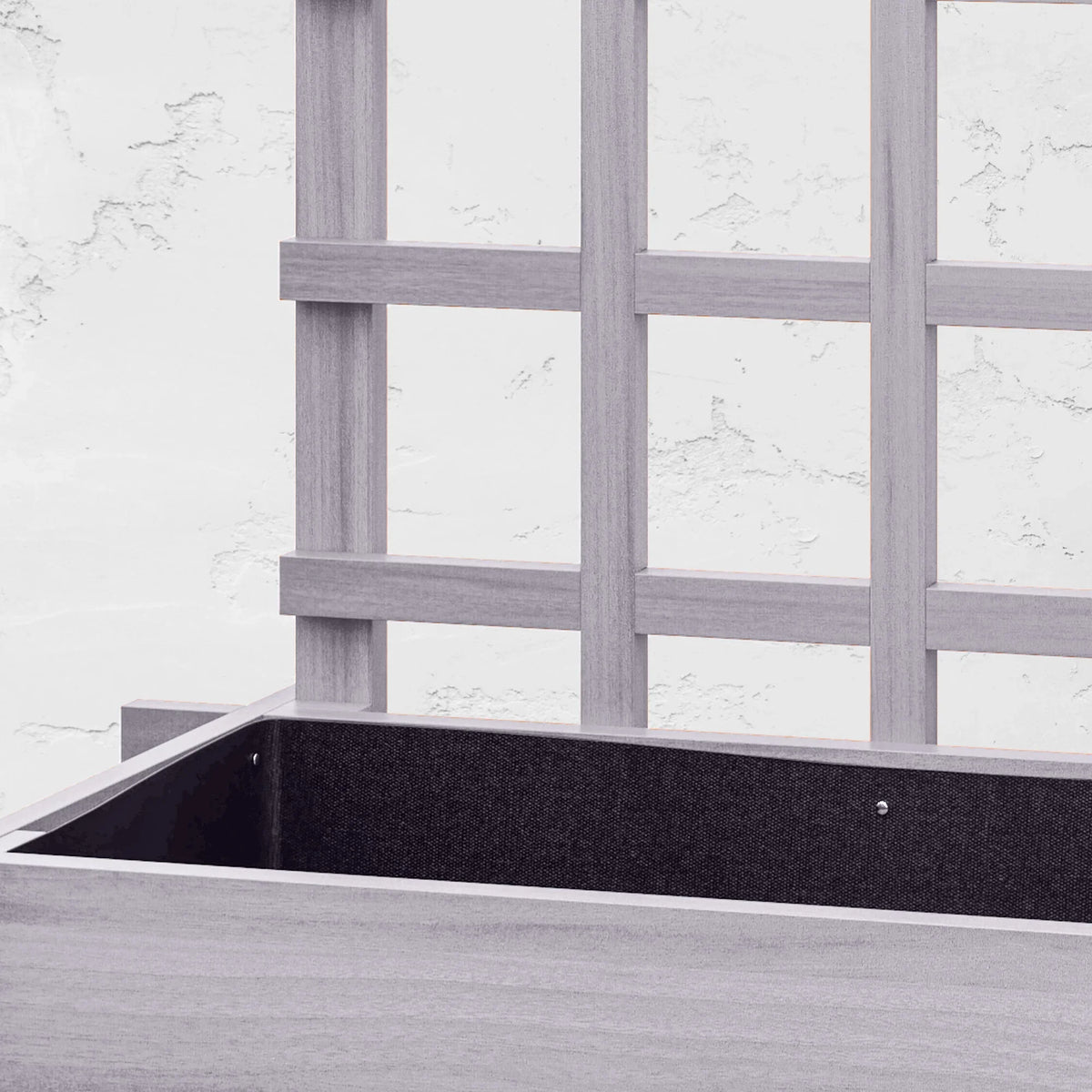 Grey trellis planter with black bed liner inside the top compartment, close-up