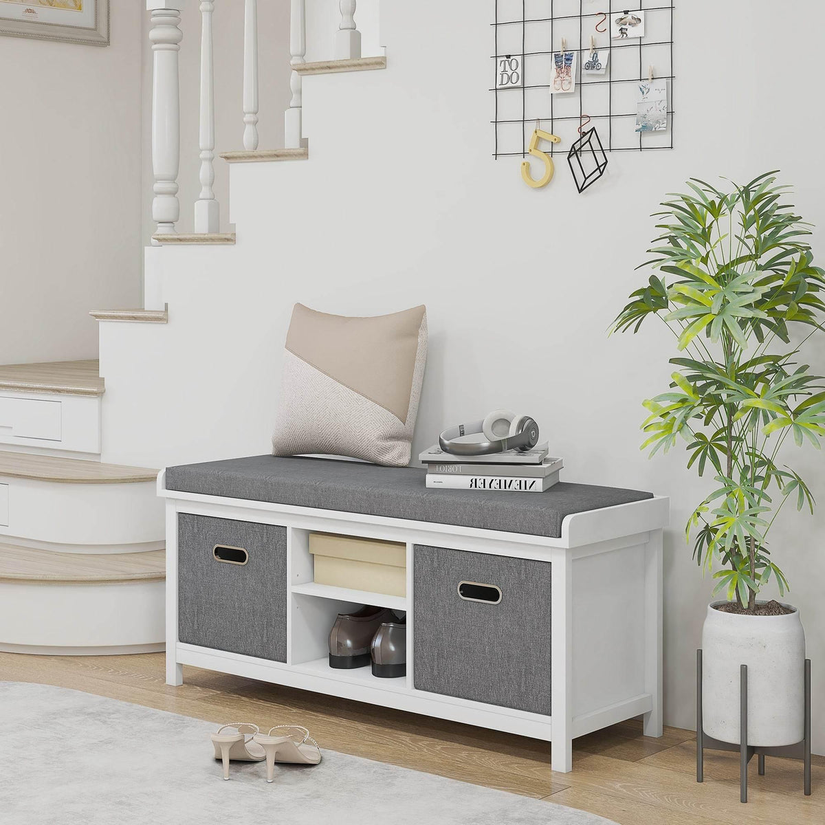 Shoe storage bench with gray cushioned top, open shoe compartments, white frame