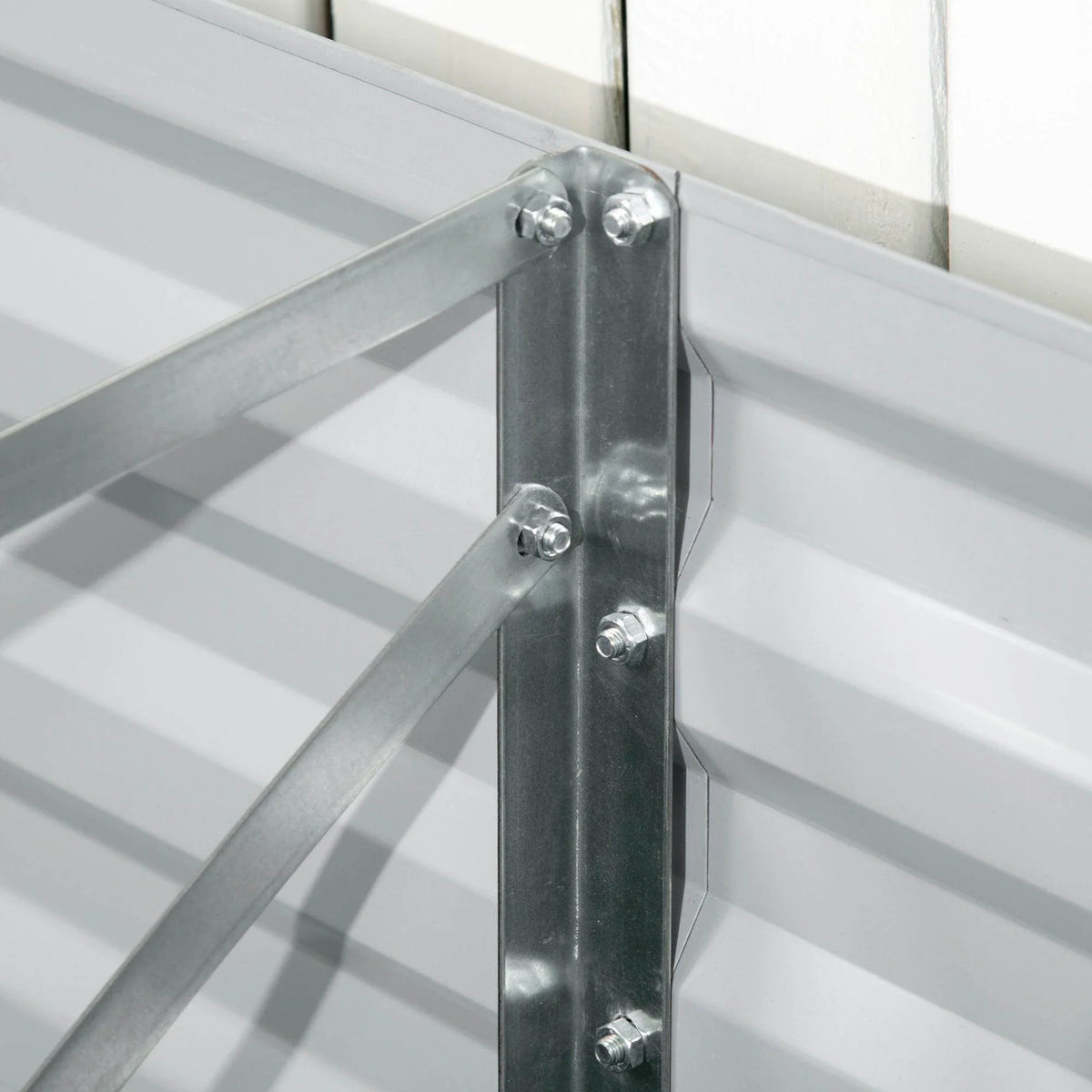 Light grey galvanized raised bed corner with metal bracket and bolt hardware