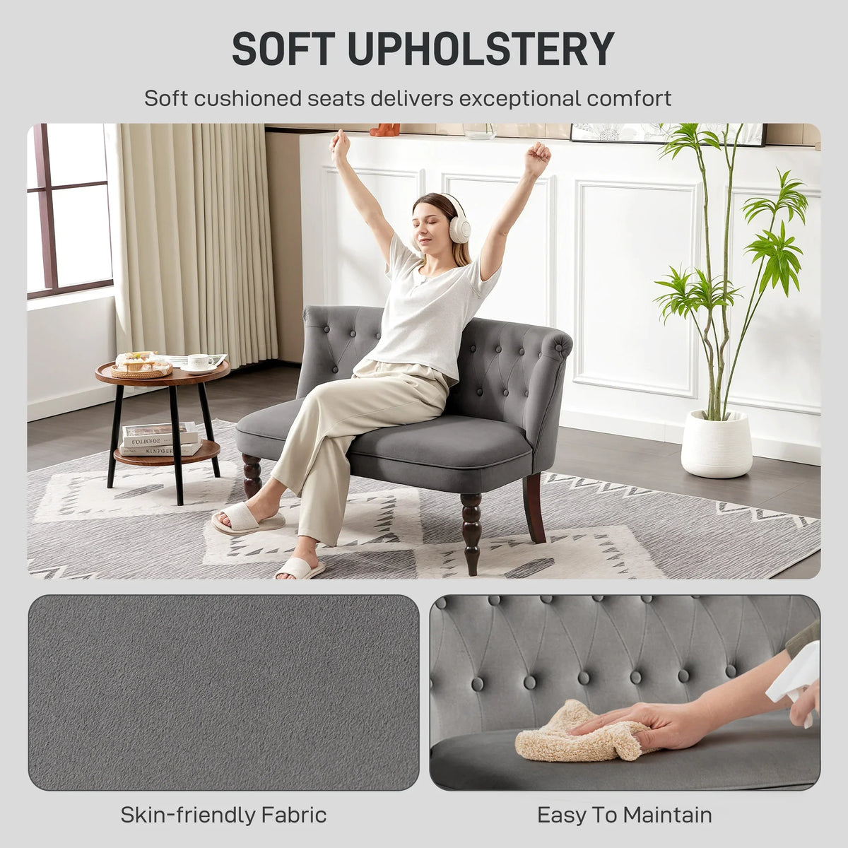 Charcoal grey upholstered wingback loveseat sofa with tufted back, rounded seat, dark wood legs.