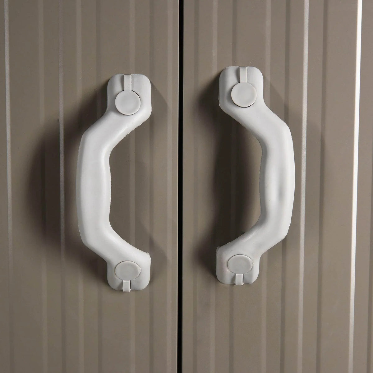 White recessed door handle on grey metal shed door panel