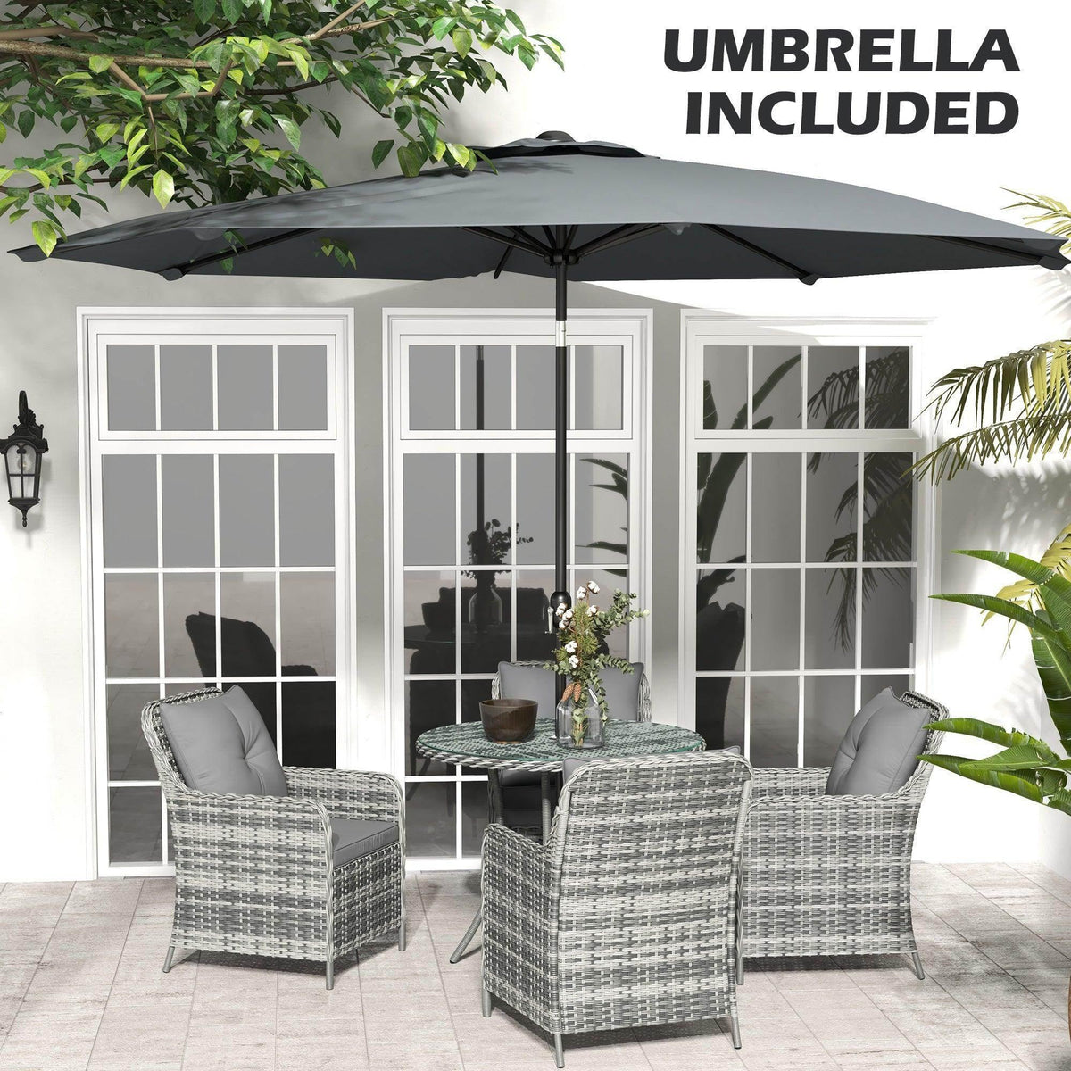 Outdoor dining set with included umbrella over gray rattan chairs and round glass table