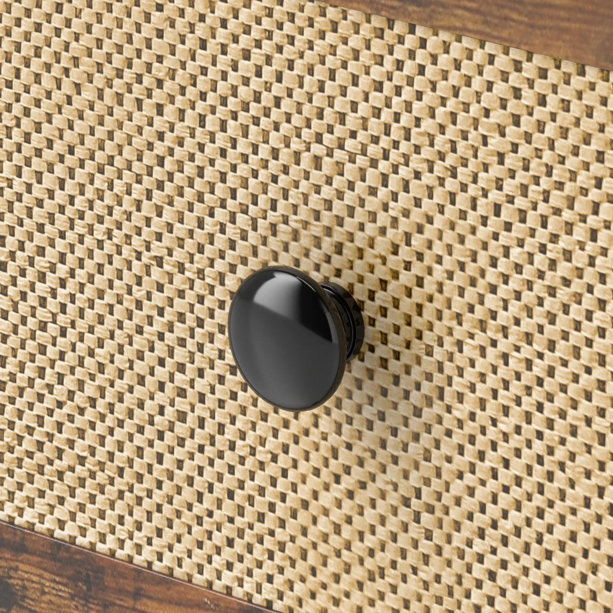 Close-up of woven rattan drawer front with round black knob