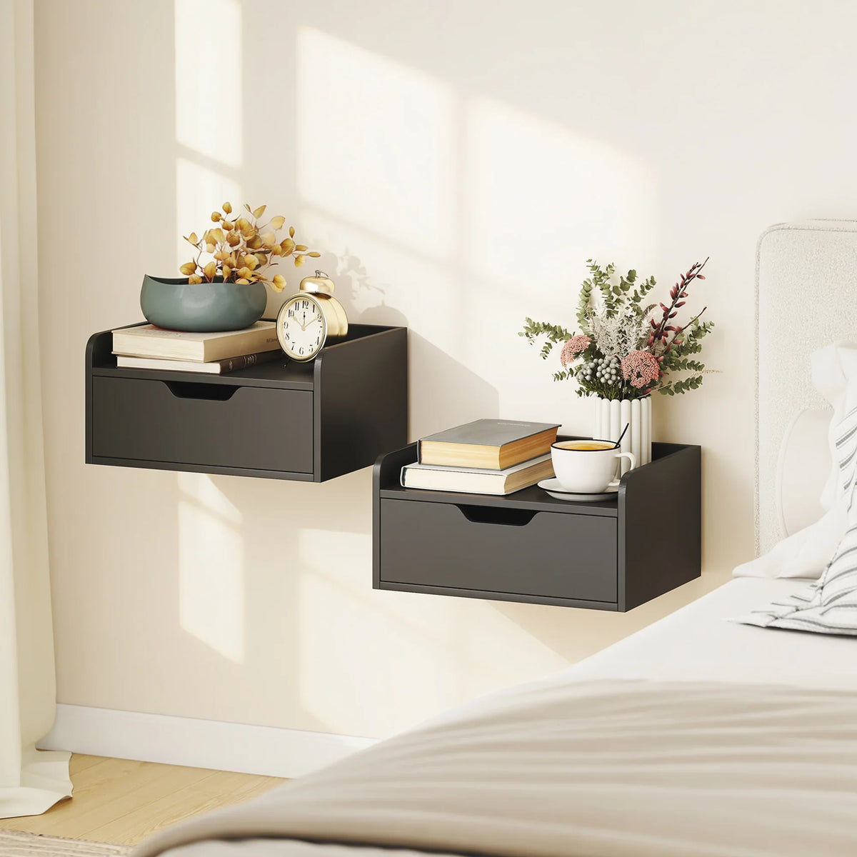 Black floating wall nightstand with drawer, styled bedside storage on wall