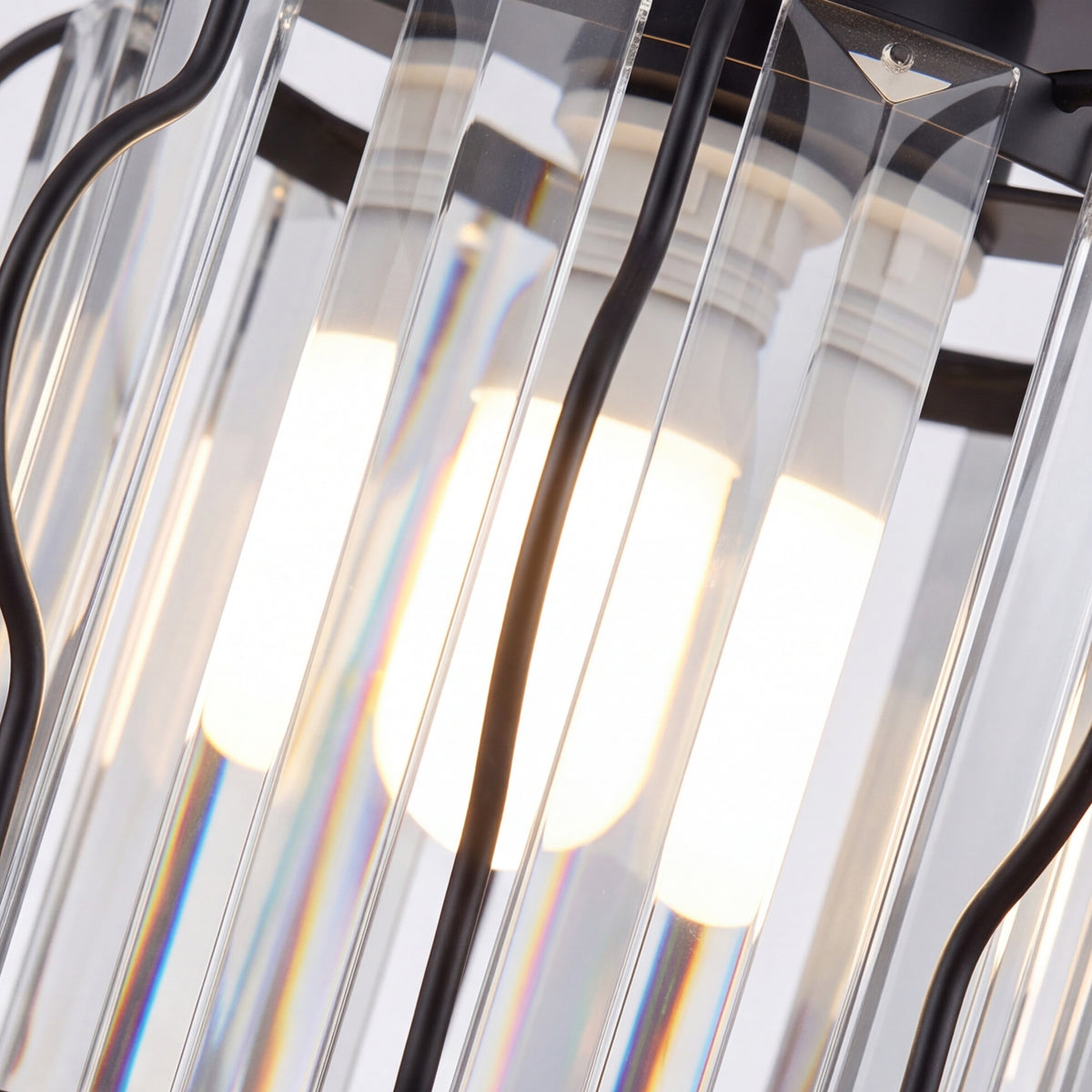 Close-up of clear crystal bars inside a black semi-flush mount ceiling light