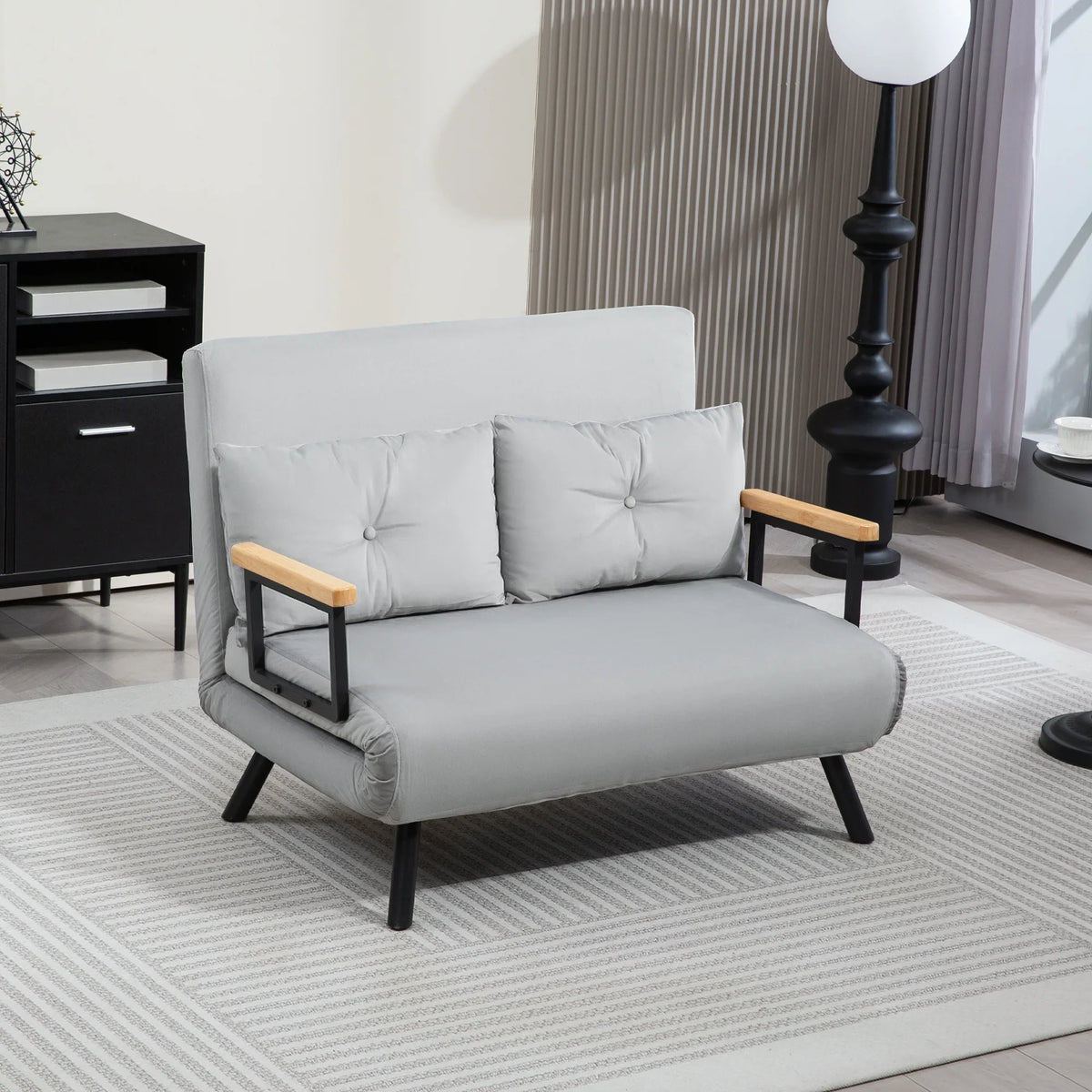 Light grey velvet-look sofa bed with tufted back cushions and wooden armrests, front view