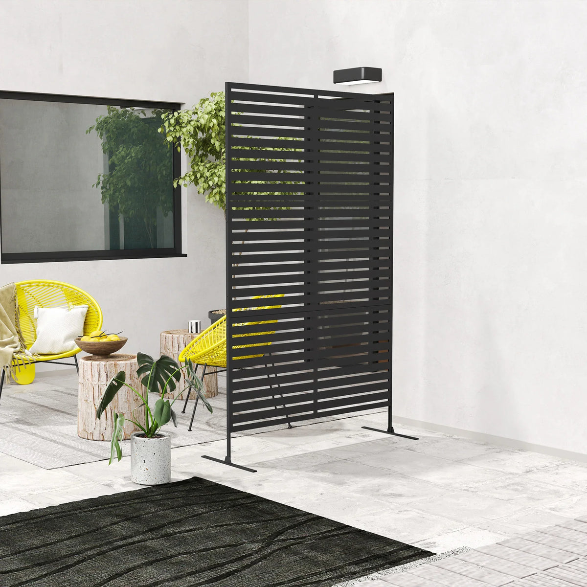 Black metal privacy screen trellis on stand beside patio seating