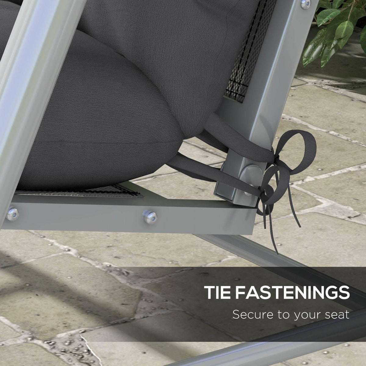 Charcoal grey outdoor chair cushion with tie straps securing to frame