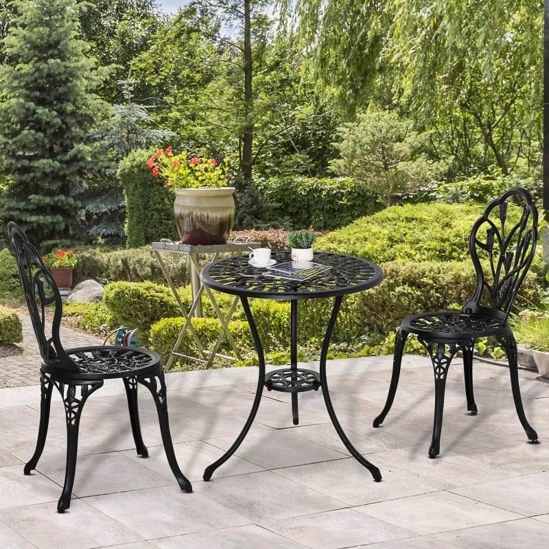 Black aluminum bistro table and two floral lattice chairs for outdoor patio seating