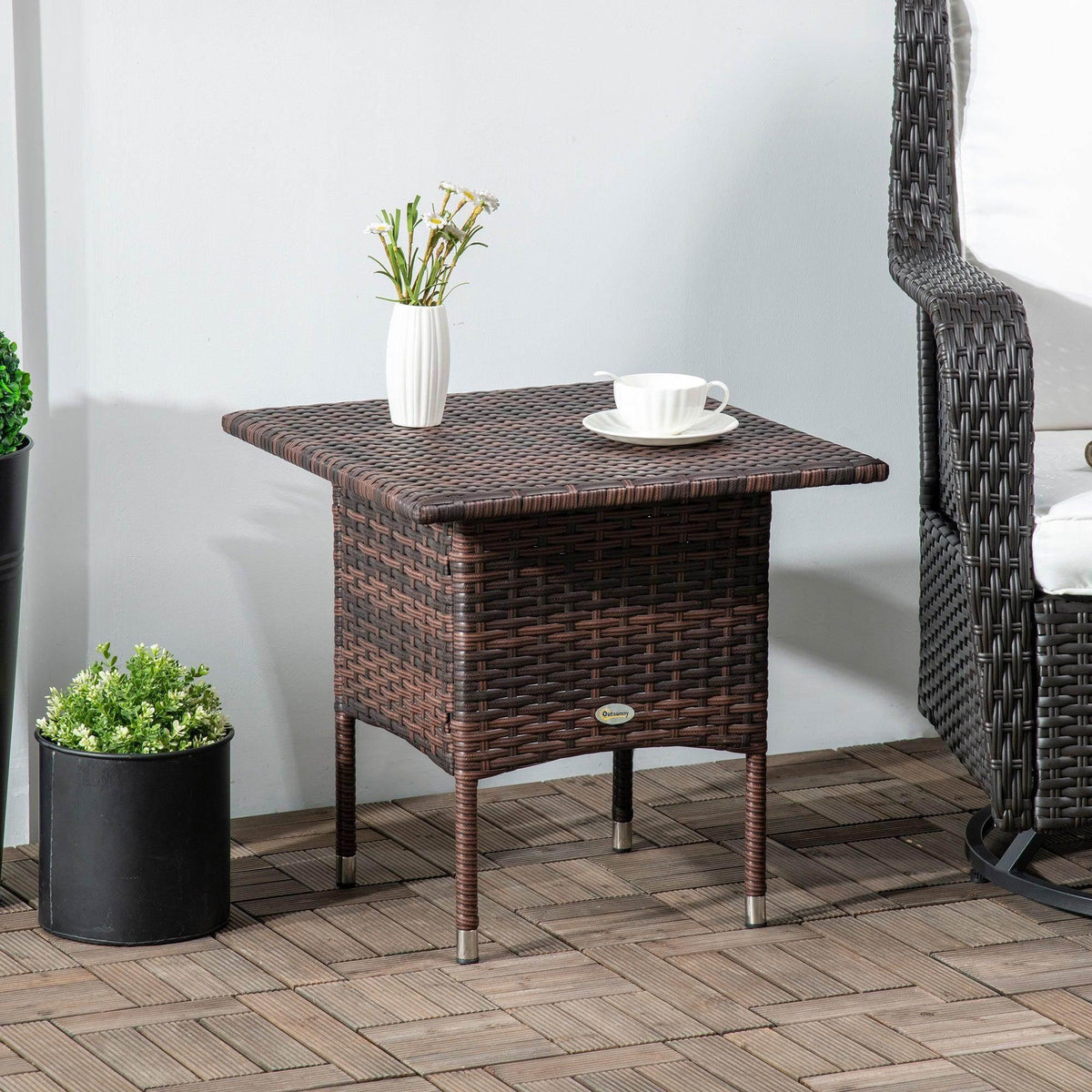 Outdoor rattan side table with woven top and brown square tabletop, four metal legs