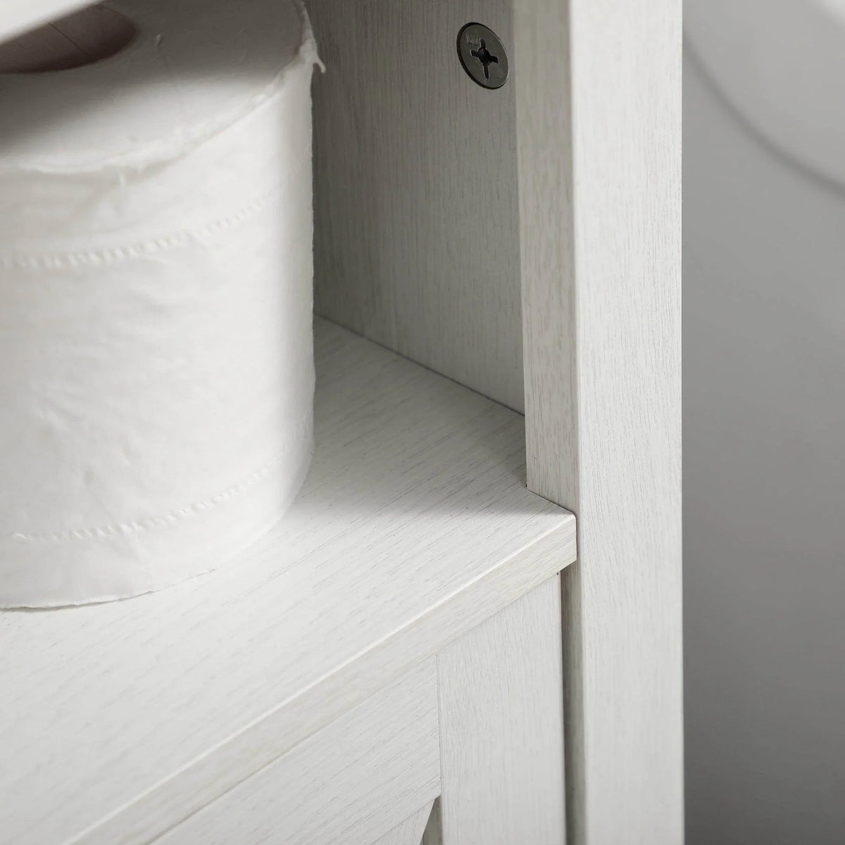 White vanity cabinet interior corner with open shelf space and side panel detail