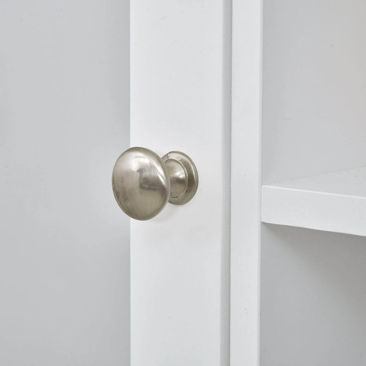 White cabinet door with round metal knob hardware