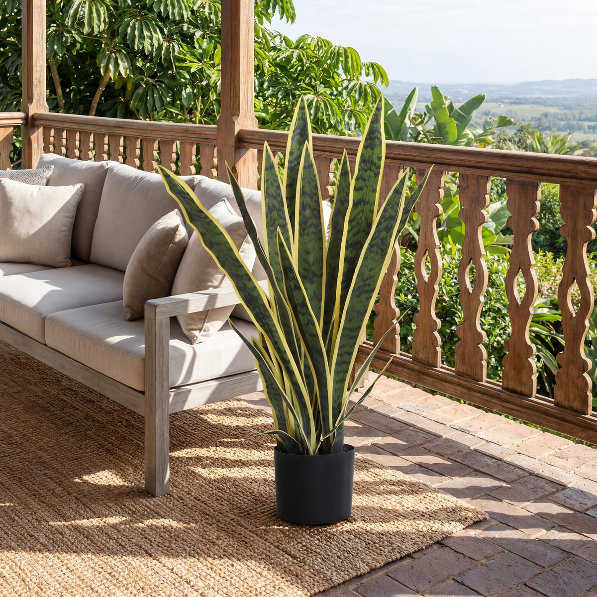 Artificial snake plant with variegated leaves in black pot for outdoor patio
