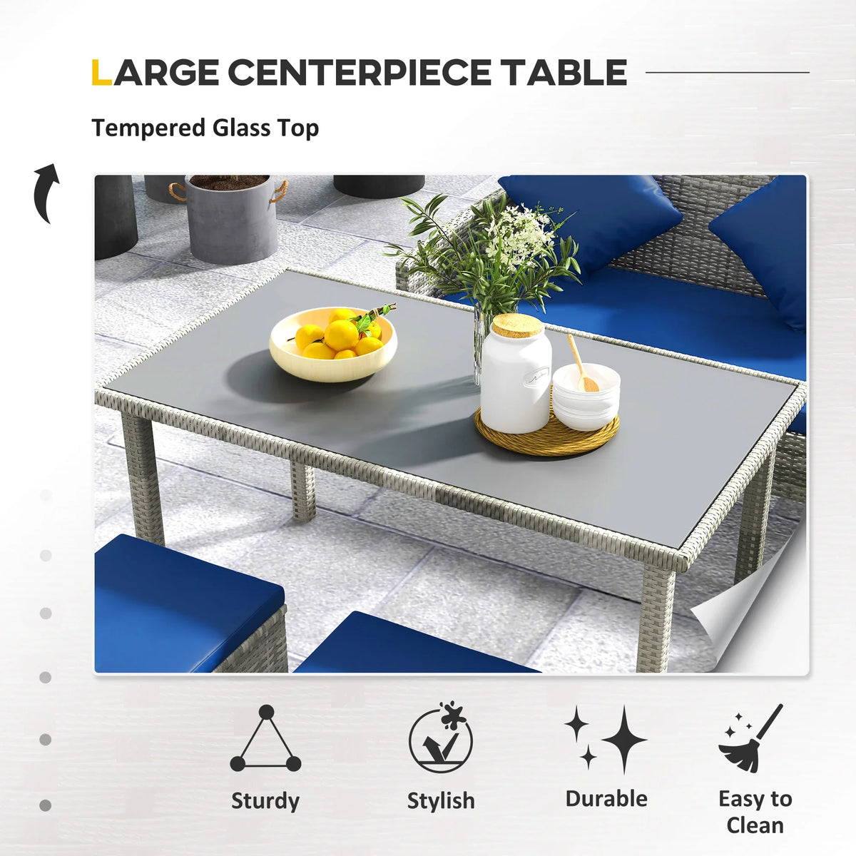 Tempered glass dining table with light gray rattan frame and blue seat cushions