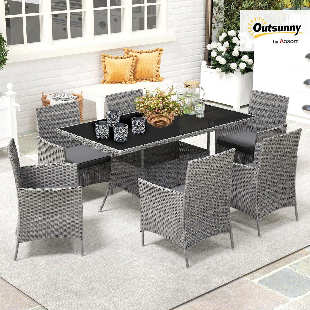 Outsunny charcoal grey rattan dining set with glass-top table and six chairs on patio