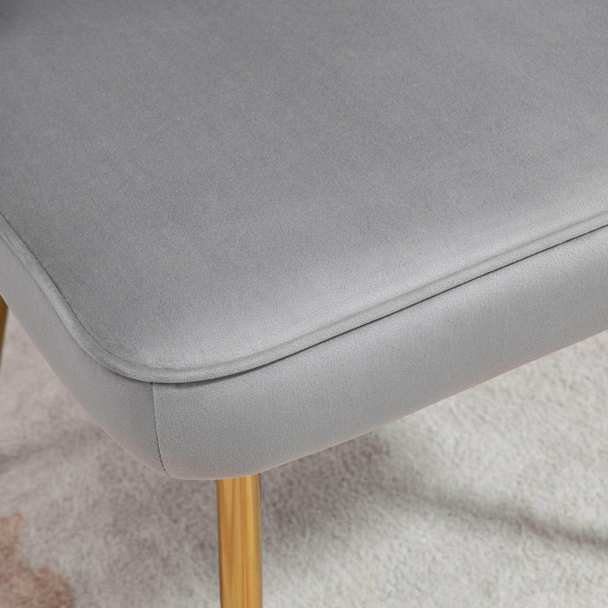 Grey velvet chair seat with rounded edge and smooth padded cushioning