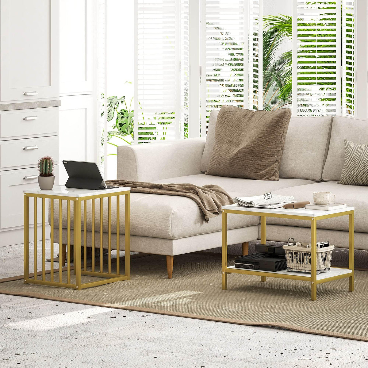 Gold-framed nesting side table set with faux marble tops beside a sofa
