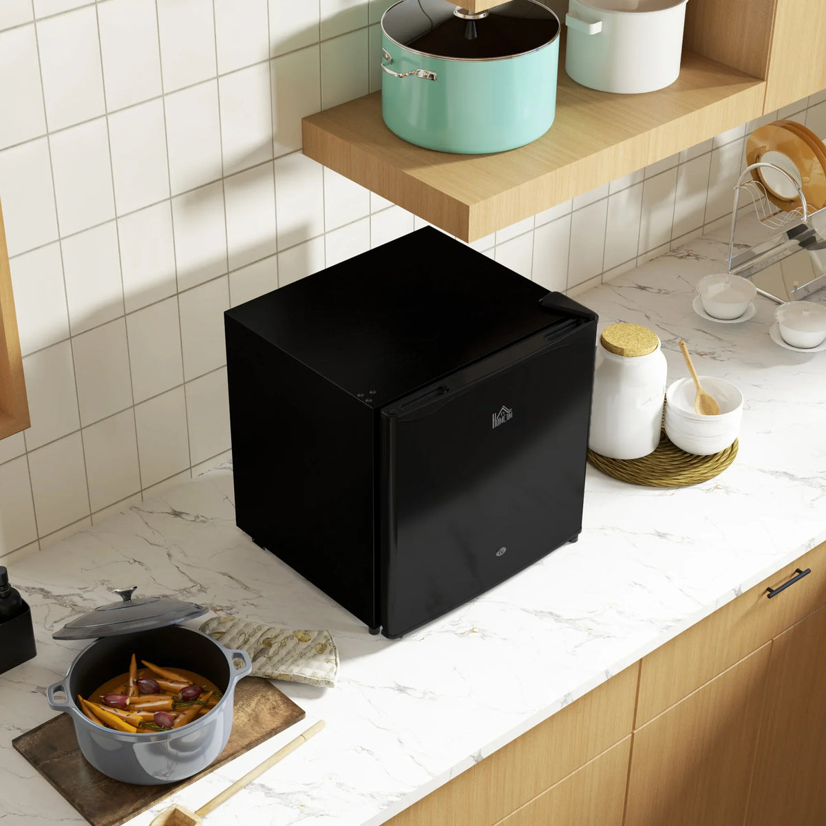 Black mini fridge on countertop with open door facing left
