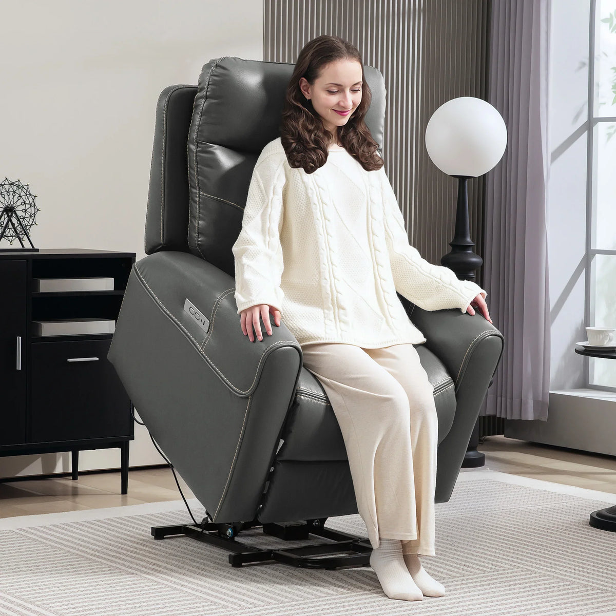 Charcoal gray power lift recliner chair with cushioned arms and reclining seat