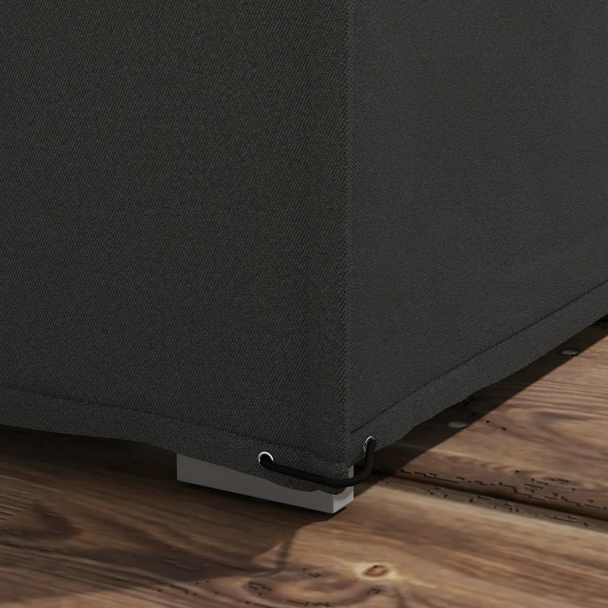 Black outdoor furniture cover fabric with stitched hem and securing strap at base