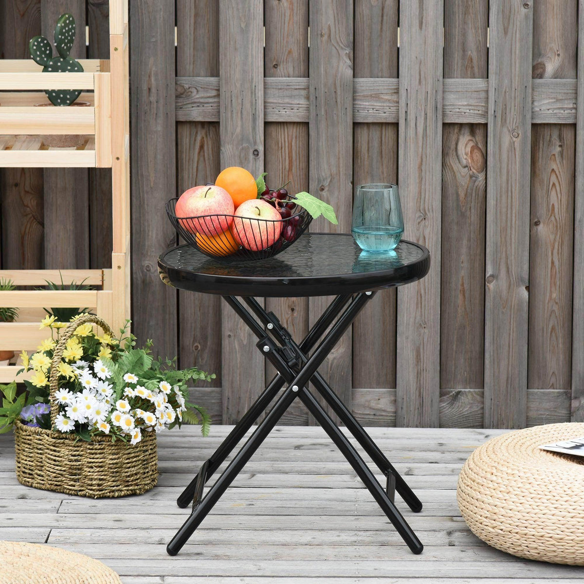 Black round folding garden table with tempered glass tabletop and X-frame legs