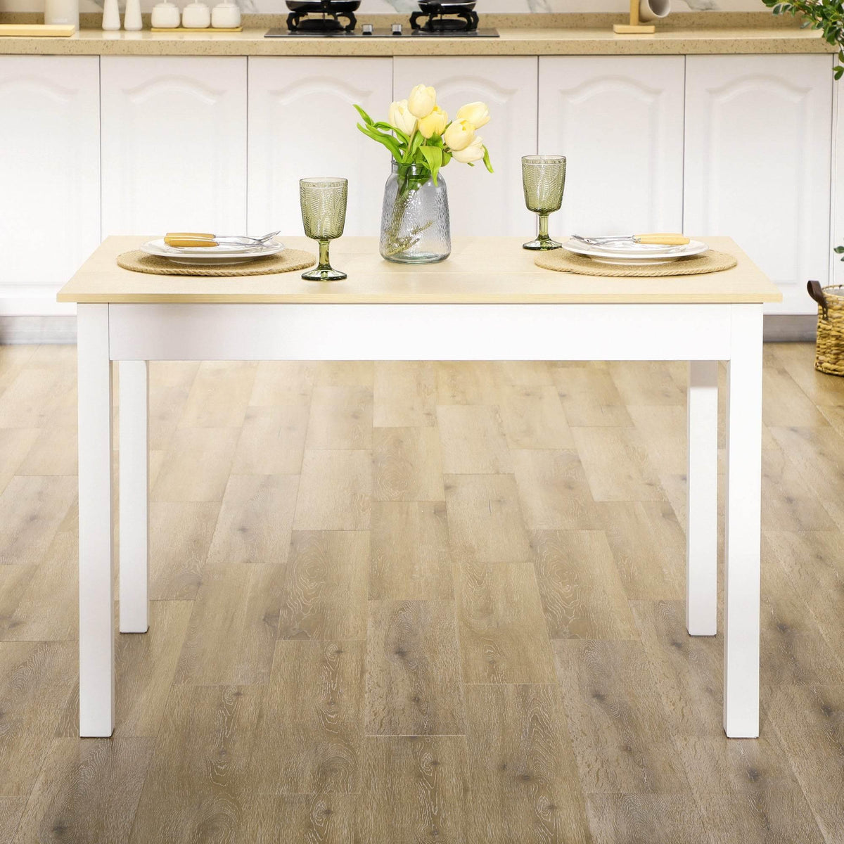 Rectangular dining table with oak-look top and white legs, set for tableware