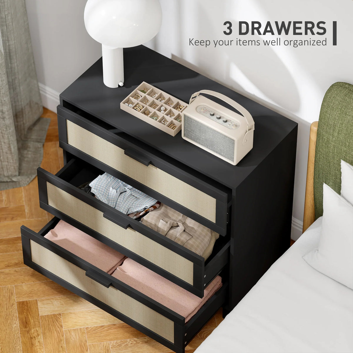 Black 3-drawer rattan chest with three beige drawer fronts, drawers partially open