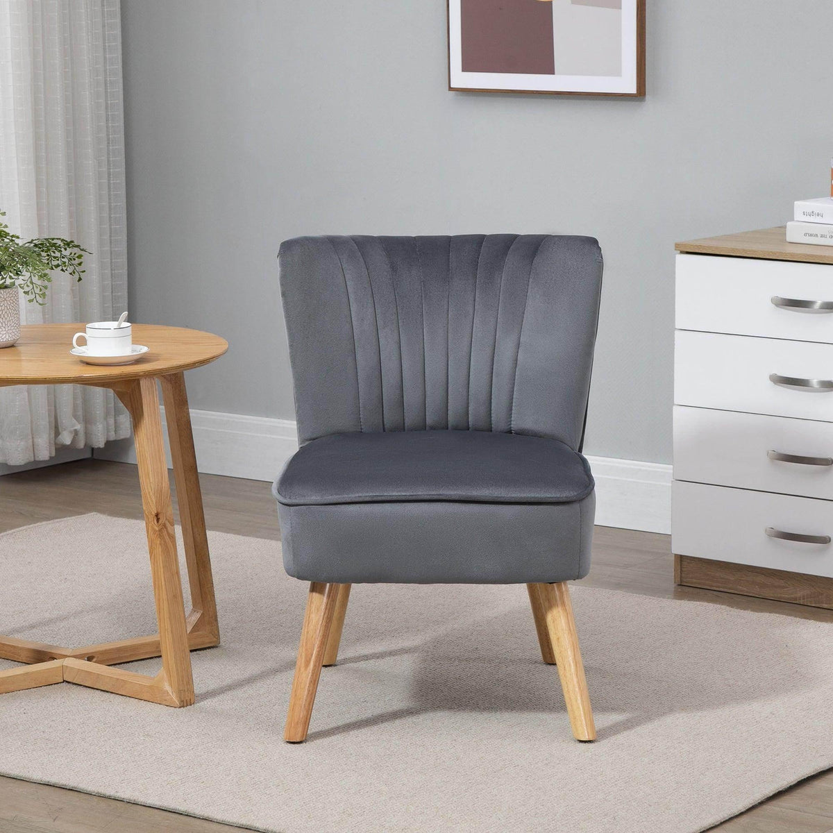 Grey velvet accent tub chair with channel-tufted back, cushioned seat, and tapered wooden legs