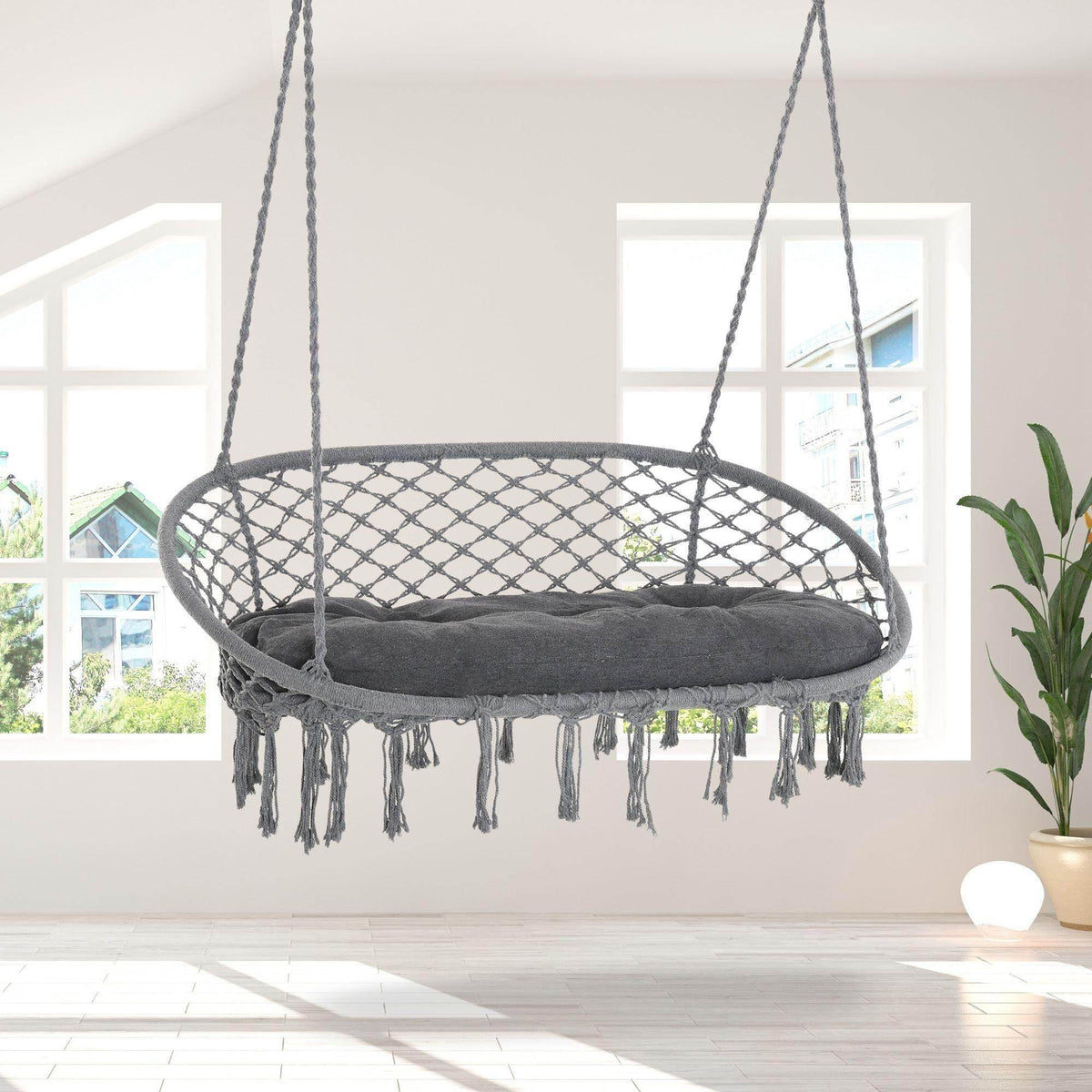 Dark grey rope hammock chair with oval macrame net and fringed cushion