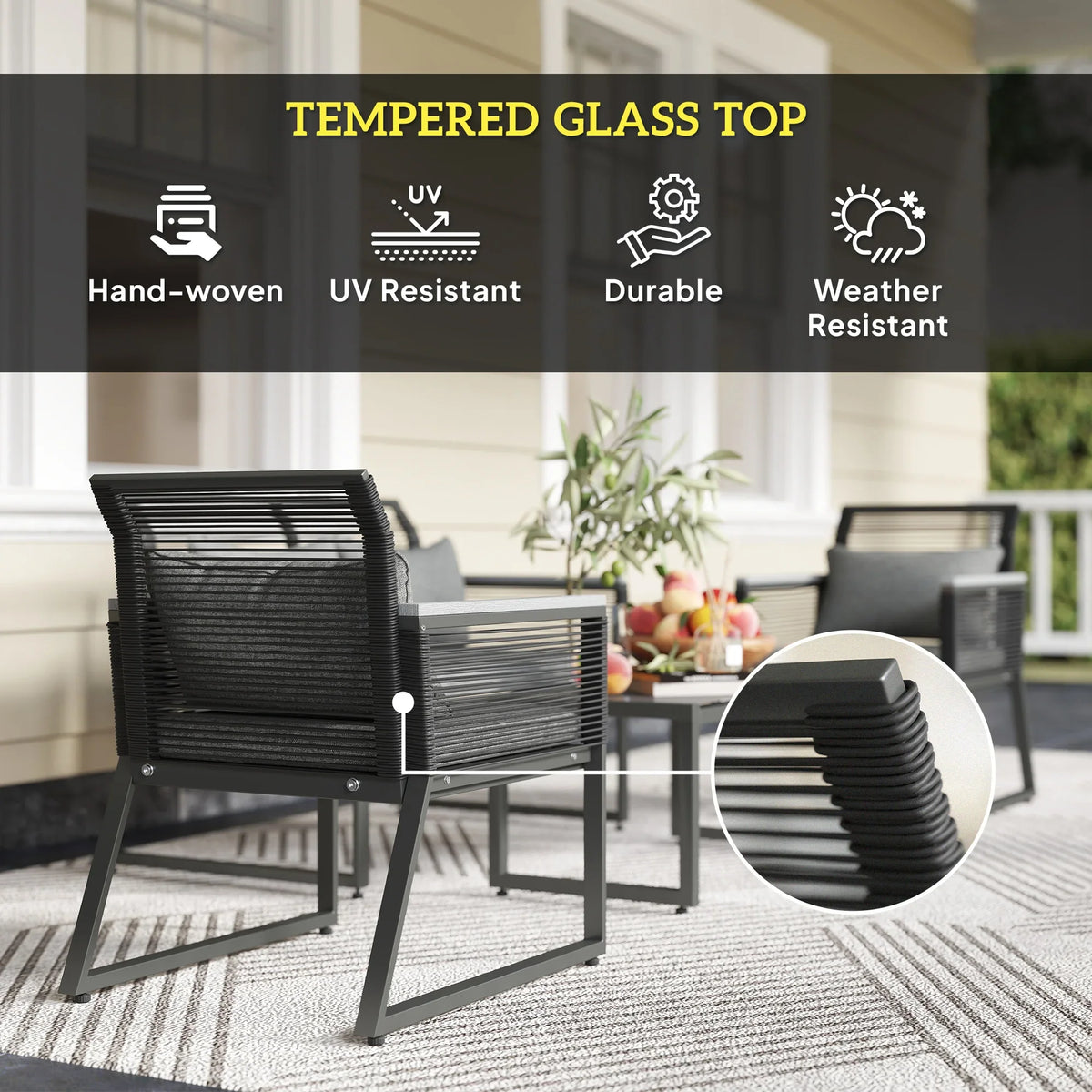 Charcoal grey rattan-style armchairs and coffee table with tempered glass top