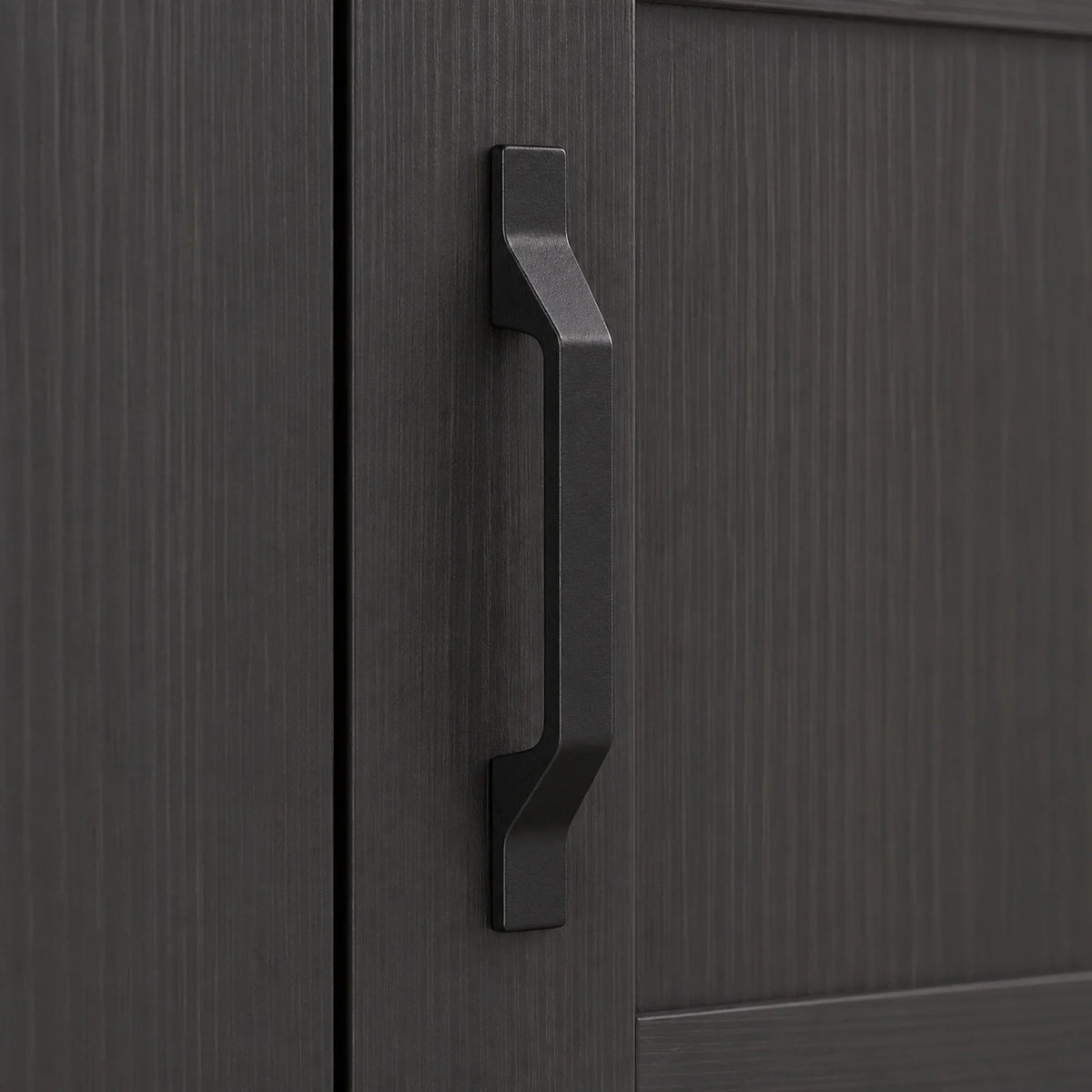 Close-up of dark gray cabinet handle on an industrial sideboard door