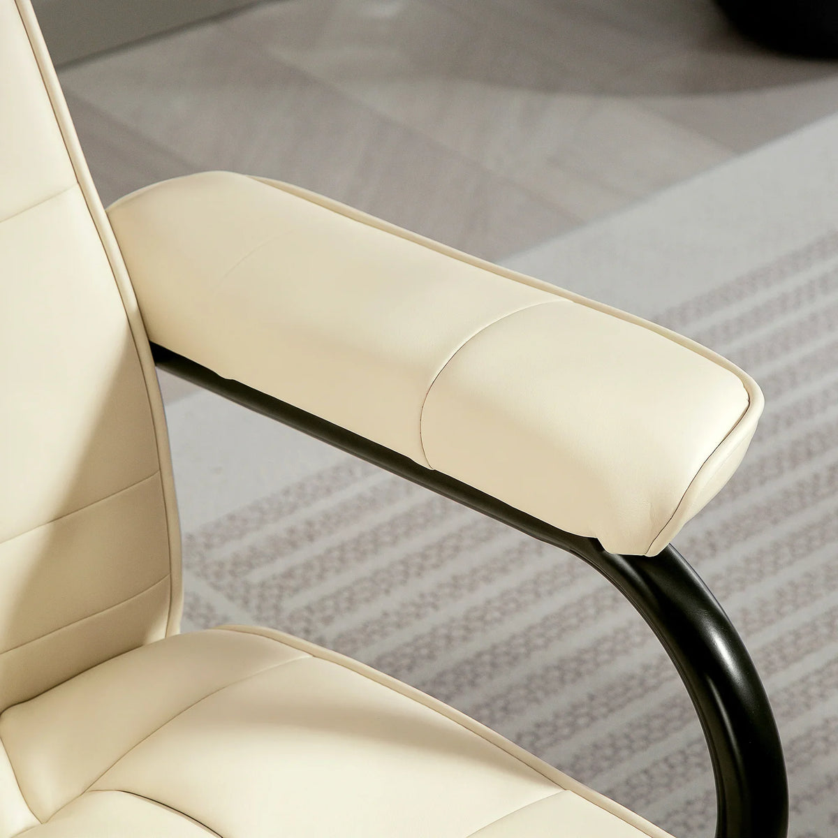 Cream faux-leather recliner chair armrest and seat cushion with black base detail.