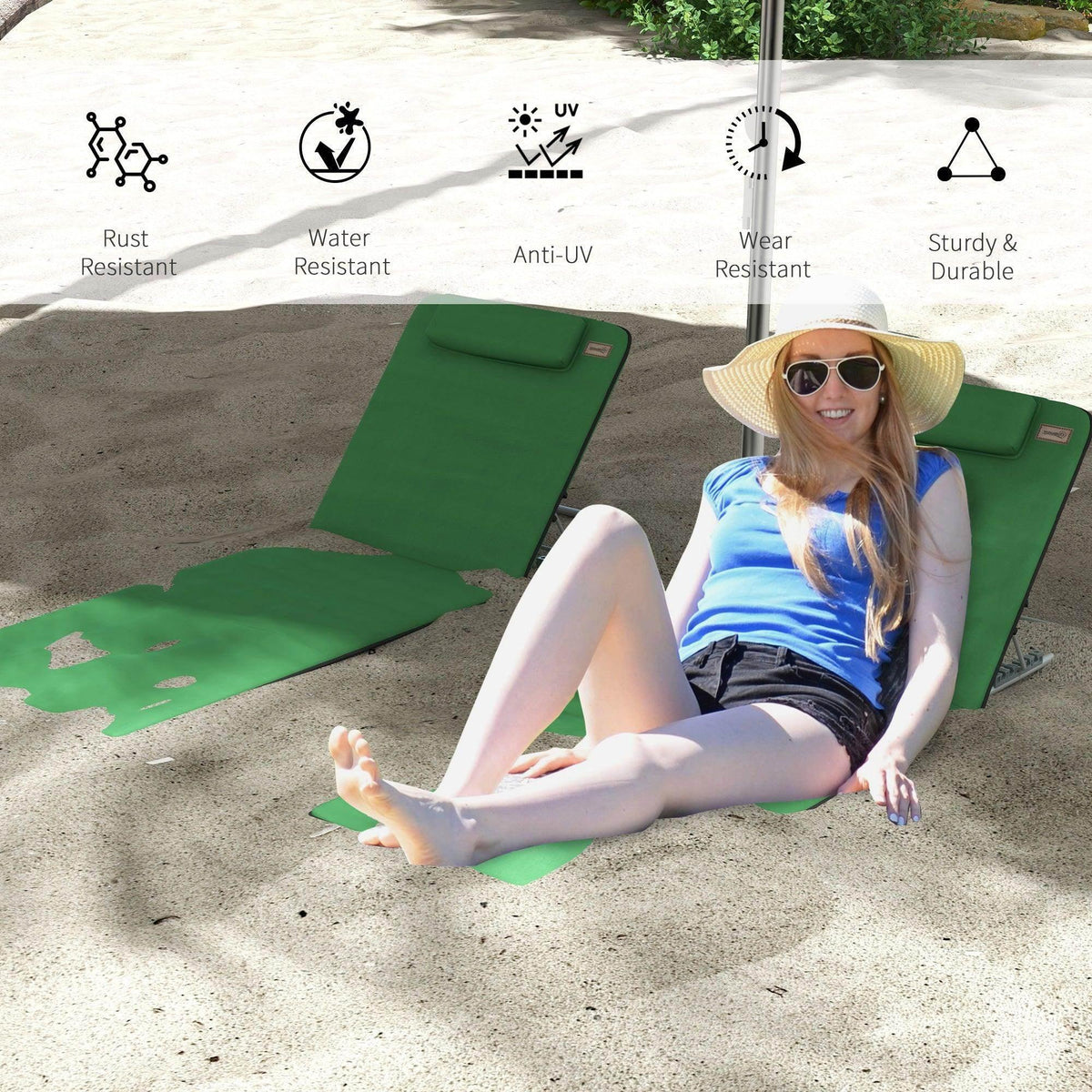 Green reclining beach chair with pillow and folding metal legs, shown with person