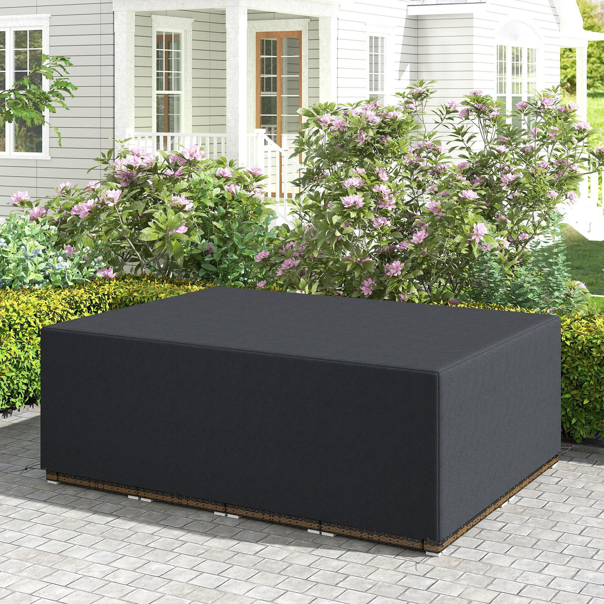 Black furniture cover draped over outdoor ottoman on patio walkway