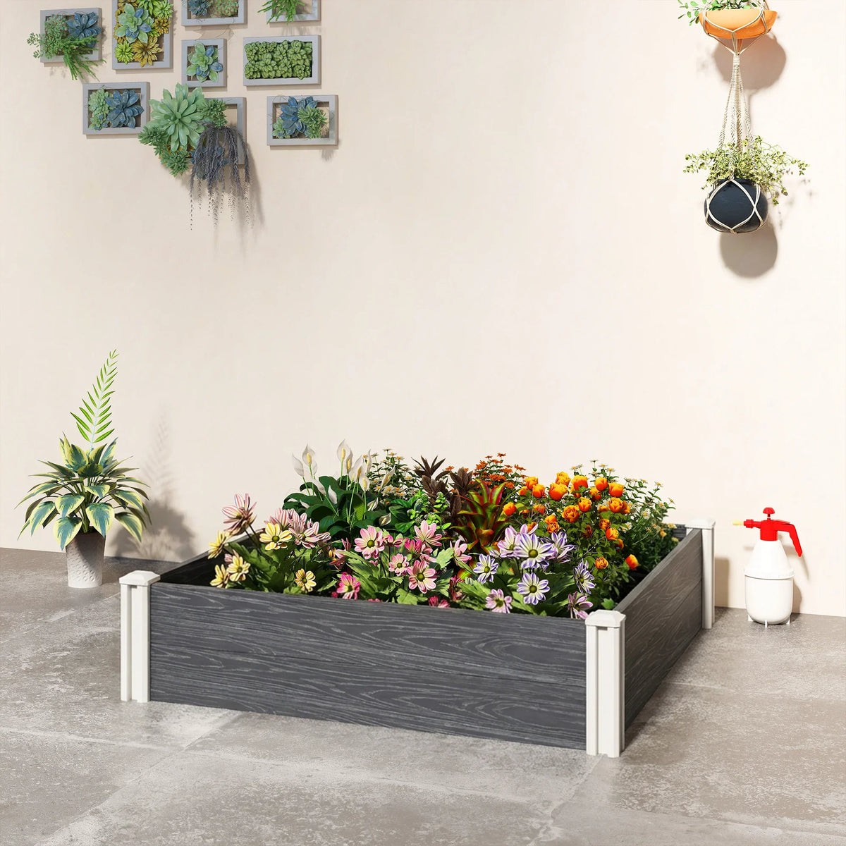Dark grey vinyl raised garden bed box with white posts on patio, planted with flowers