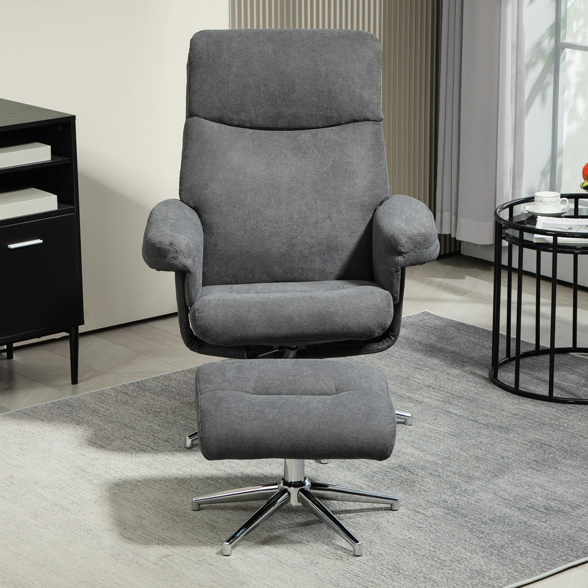Dark gray recliner chair with matching ottoman, padded arms and swivel base