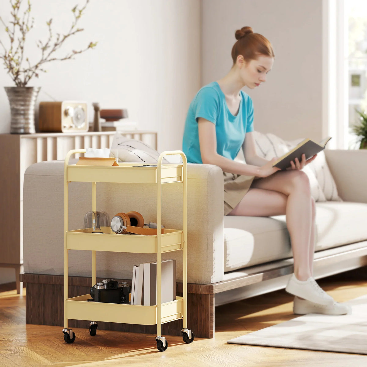Yellow rolling storage trolley with three mesh basket tiers and side handles