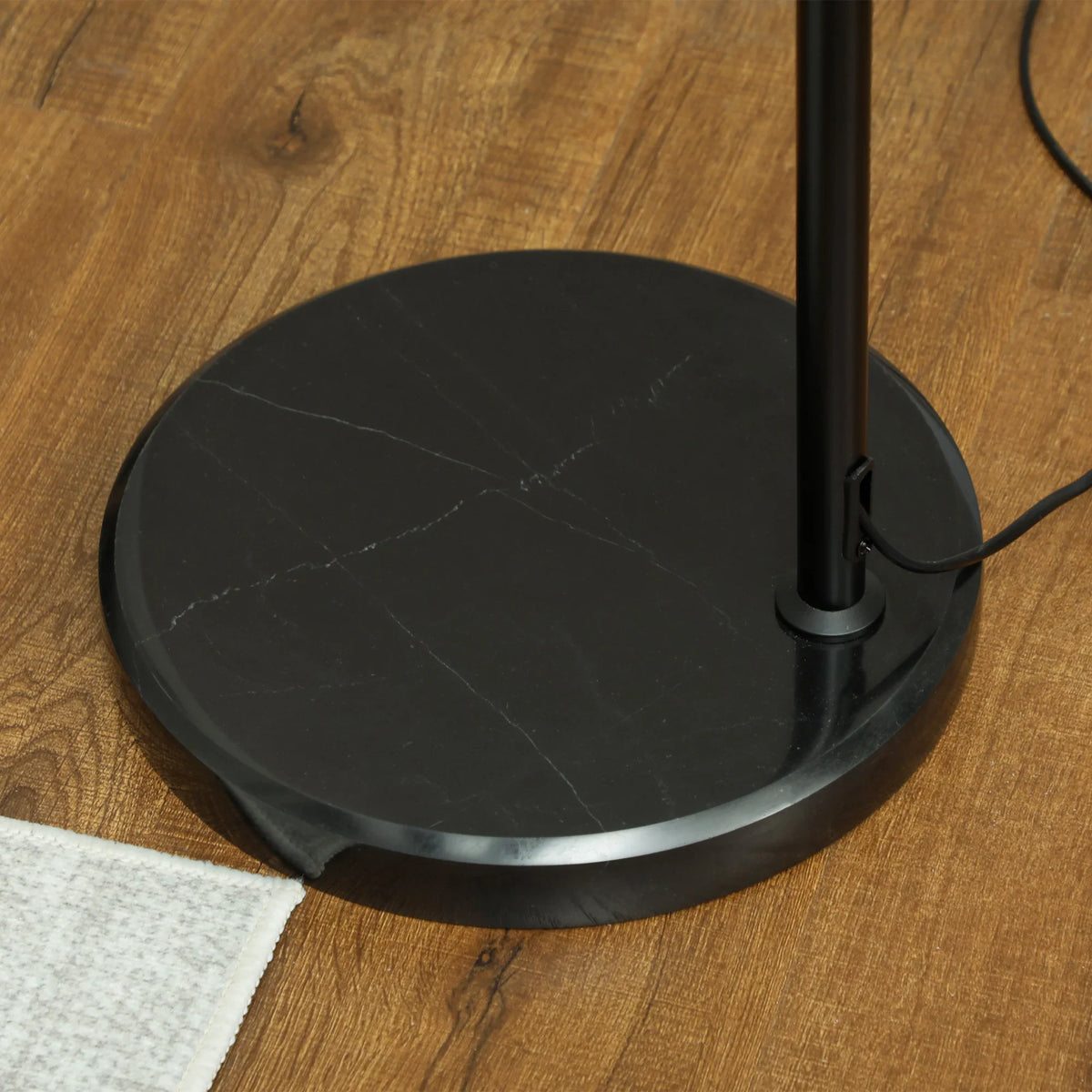Round black floor lamp base with attached arched stand pole
