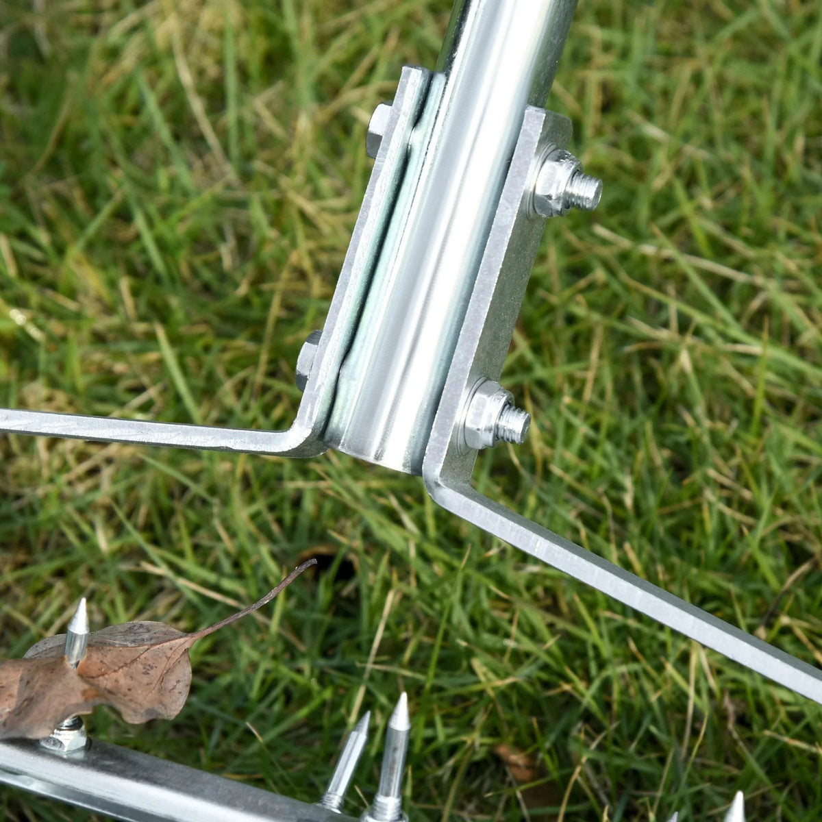 Metal handle joint with bolts and spike tips for lawn aerator