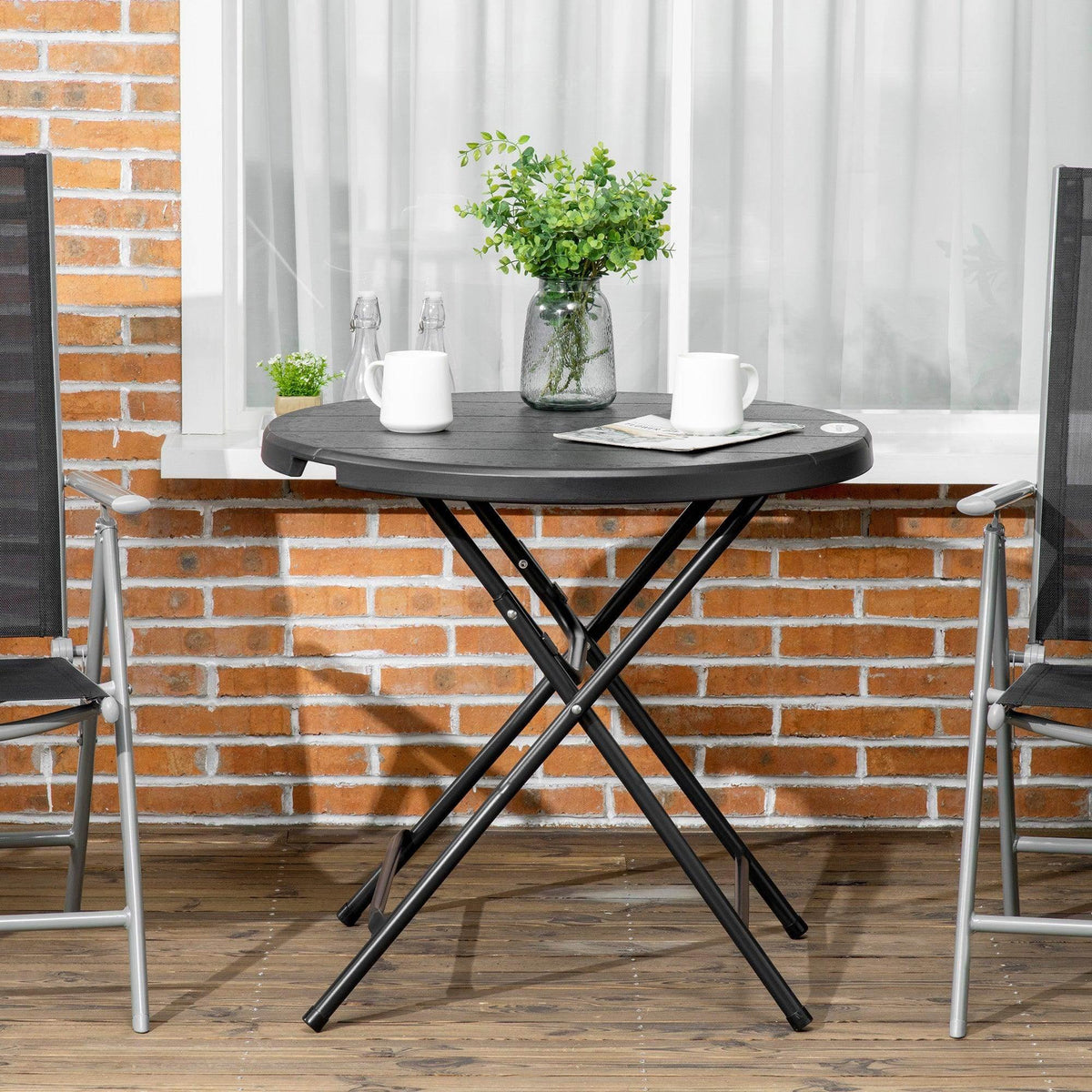 Round foldable garden dining table with dark tabletop and black X-frame base