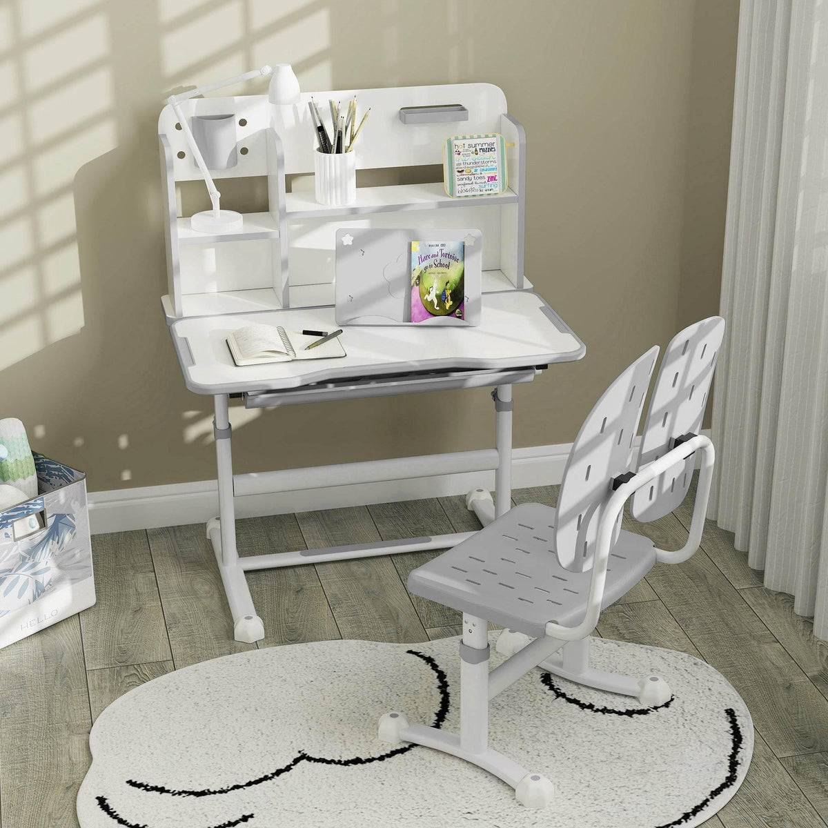 Kids adjustable desk and chair set with built-in shelves and book display