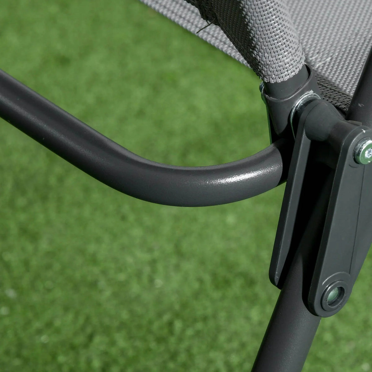 Close-up of light grey foldable armchair armrest joint and hinge connection