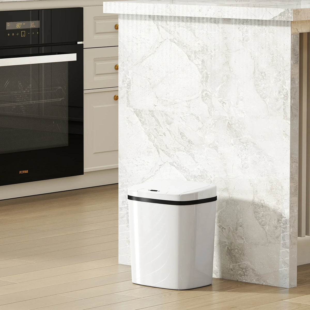 White touchless sensor kitchen bin placed against a wall near an oven