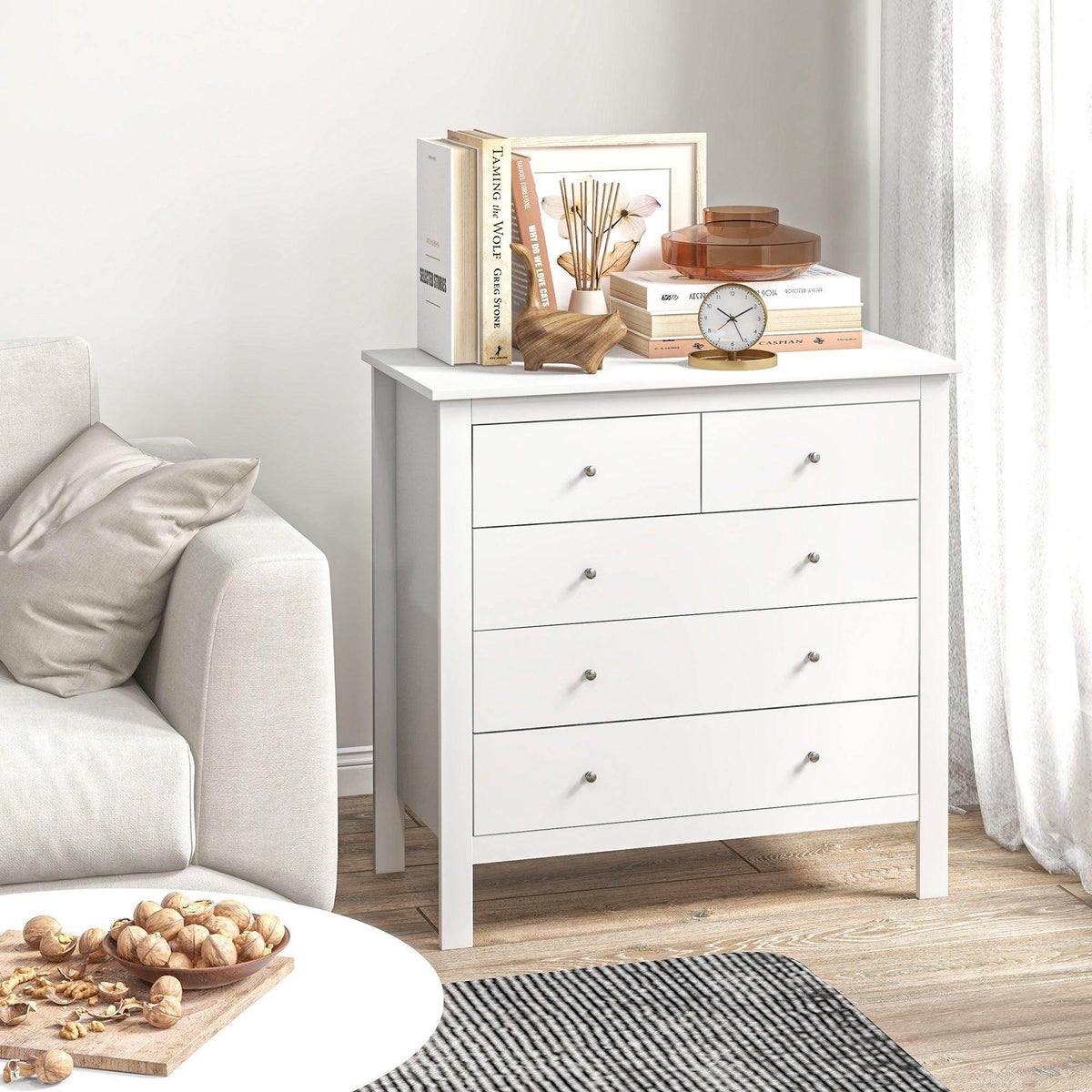 White 5-drawer storage chest with five drawer fronts and silver knob handles.