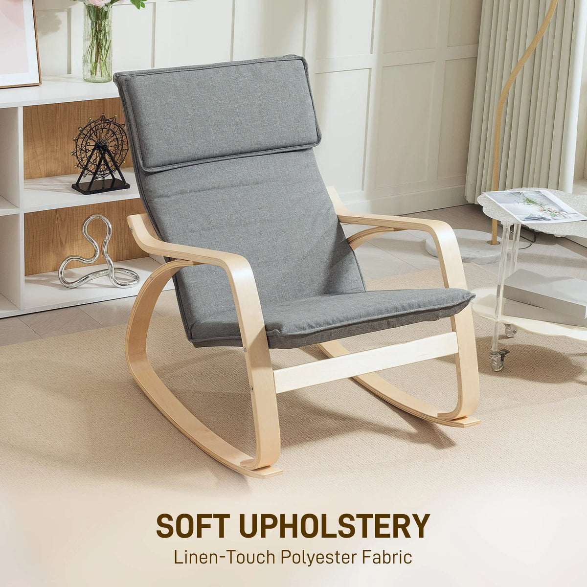 Grey upholstered high-back rocking chair with headrest, padded seat, and light wood frame