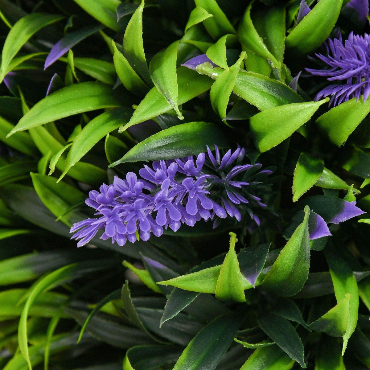Close-up of artificial ball tree foliage with purple lavender-style flower clusters